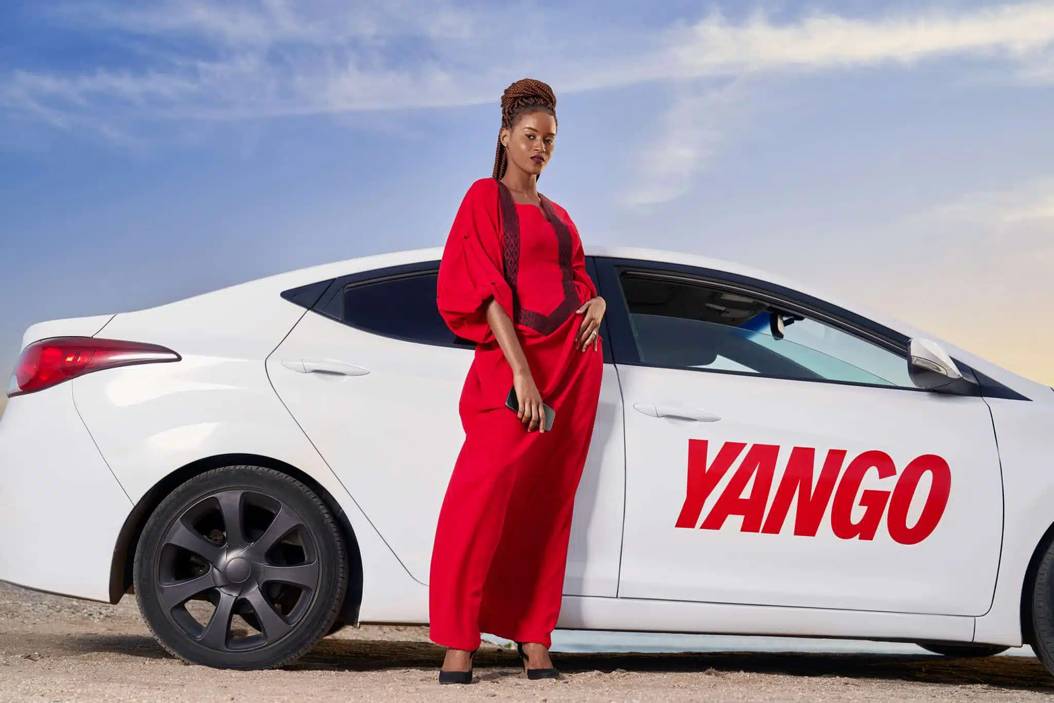 Senegalese female model fashion photography in sea side Dakar Senegal with Yango white taxi