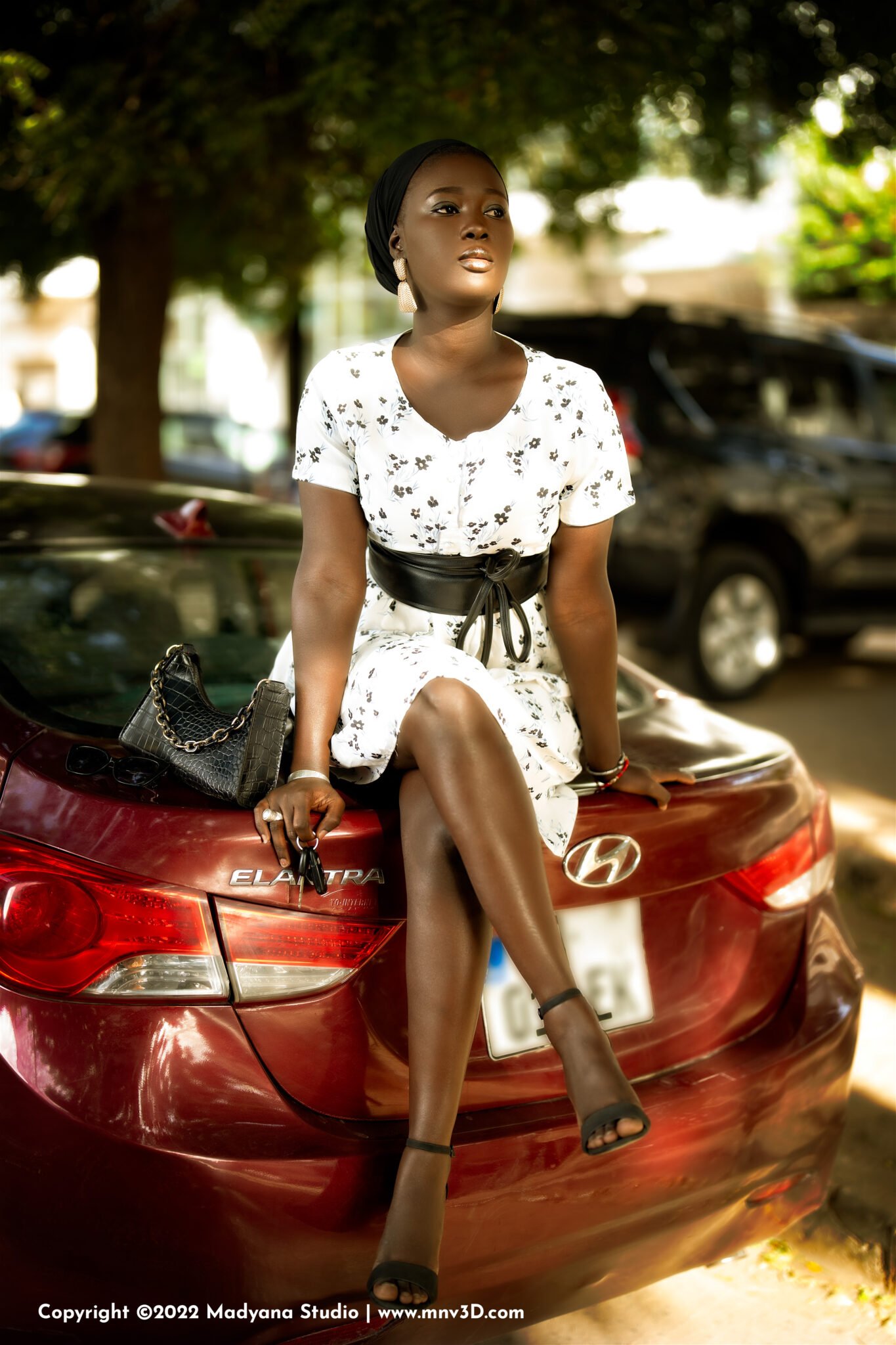 Professional Commercial photography in Dakar City road street, Senegal. Luxury fashion red car. Beautiful female African model, Kira